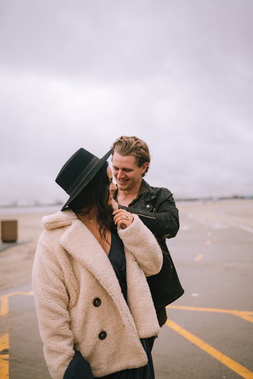 A Woman in Beige Jacket Wearing Black Hat