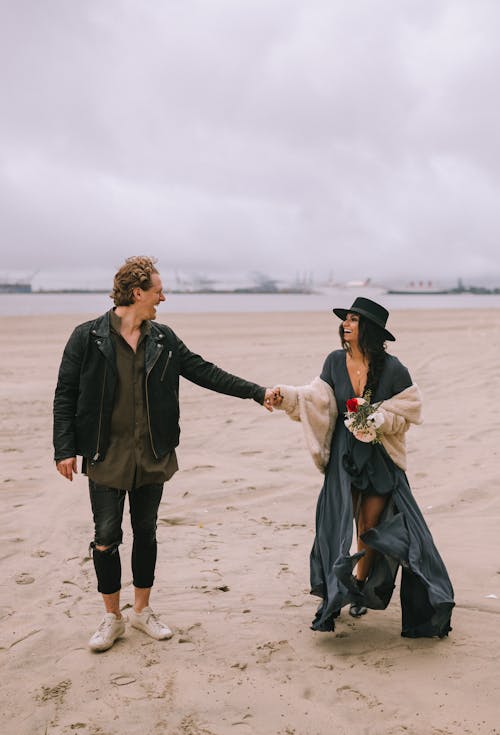 A Couple Doing Holding Hands at the Beach