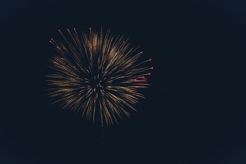 Free Golden firework displays dramatic burst against night sky, capturing celebration essence. Stock Photo