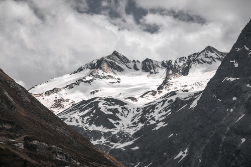 A Snow Covered Mountain Under the Cloudy Sky