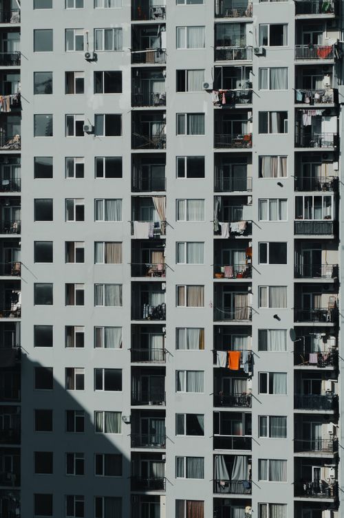 Free Close-up shot of a high-rise apartment building with balconies visible. Stock Photo