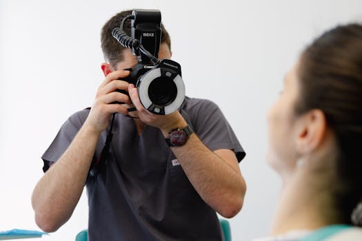 Healthcare professional taking medical photographs during patient exam session.