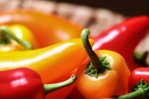 Free Colorful close-up of fresh red and yellow peppers, ideal for healthy cooking and nutrition. Stock Photo