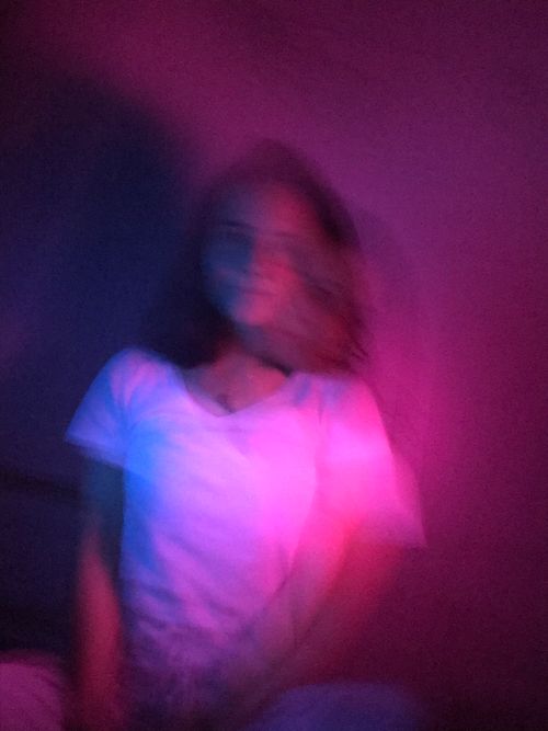 Free Artistic portrait with motion blur and vibrant pink and purple lighting effect. Stock Photo