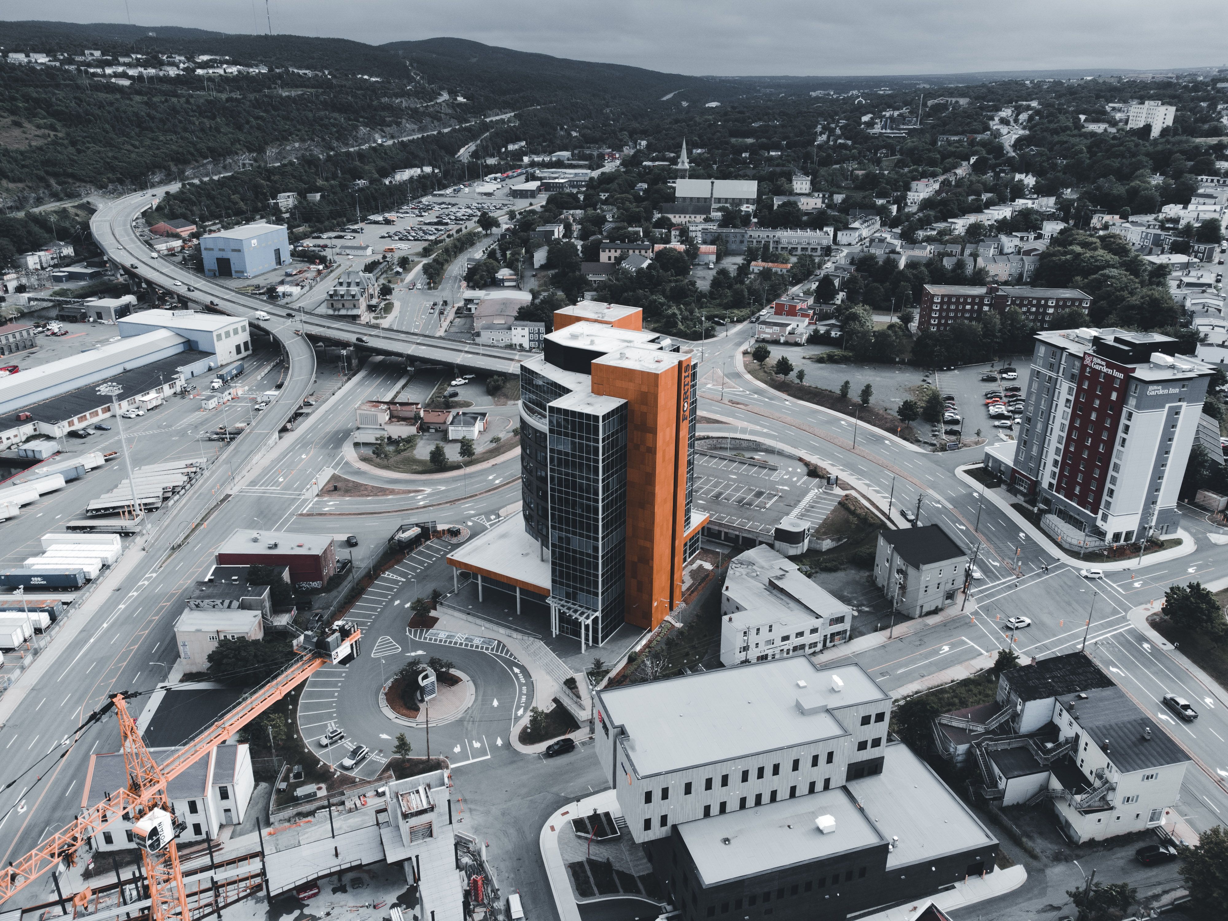 Drone photograph showcasing a cityscape with modern buildings and infrastructure.