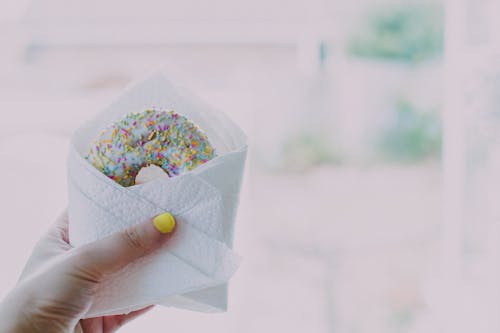 Woman Holding Doughnut With Sprinkles