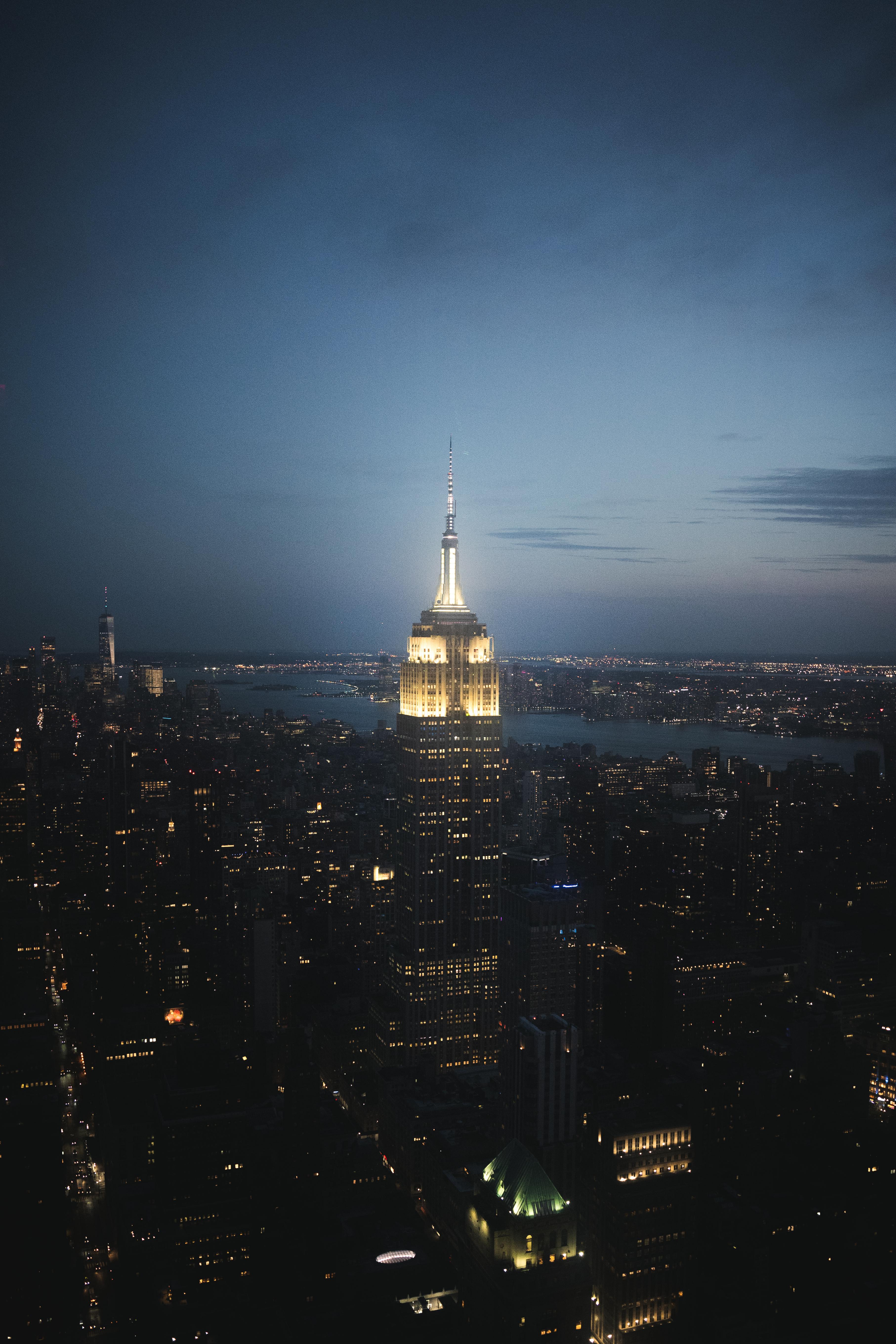 Stunning aerial view of the illuminated New York City skyline featuring the Empire State Building at night.