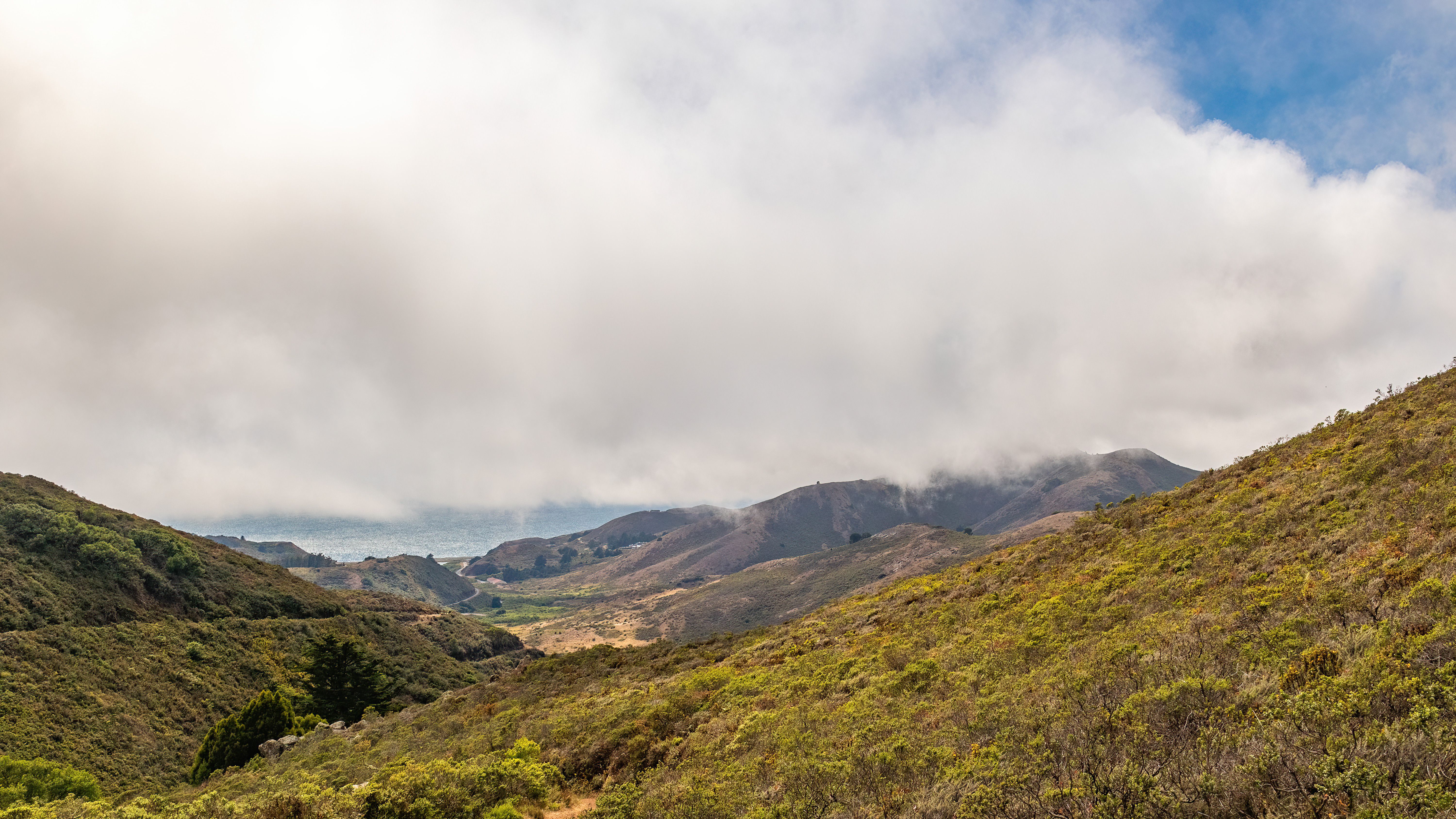 An Aerial Photography of a Mountain Under the Cloudy Sky · Free Stock Photo