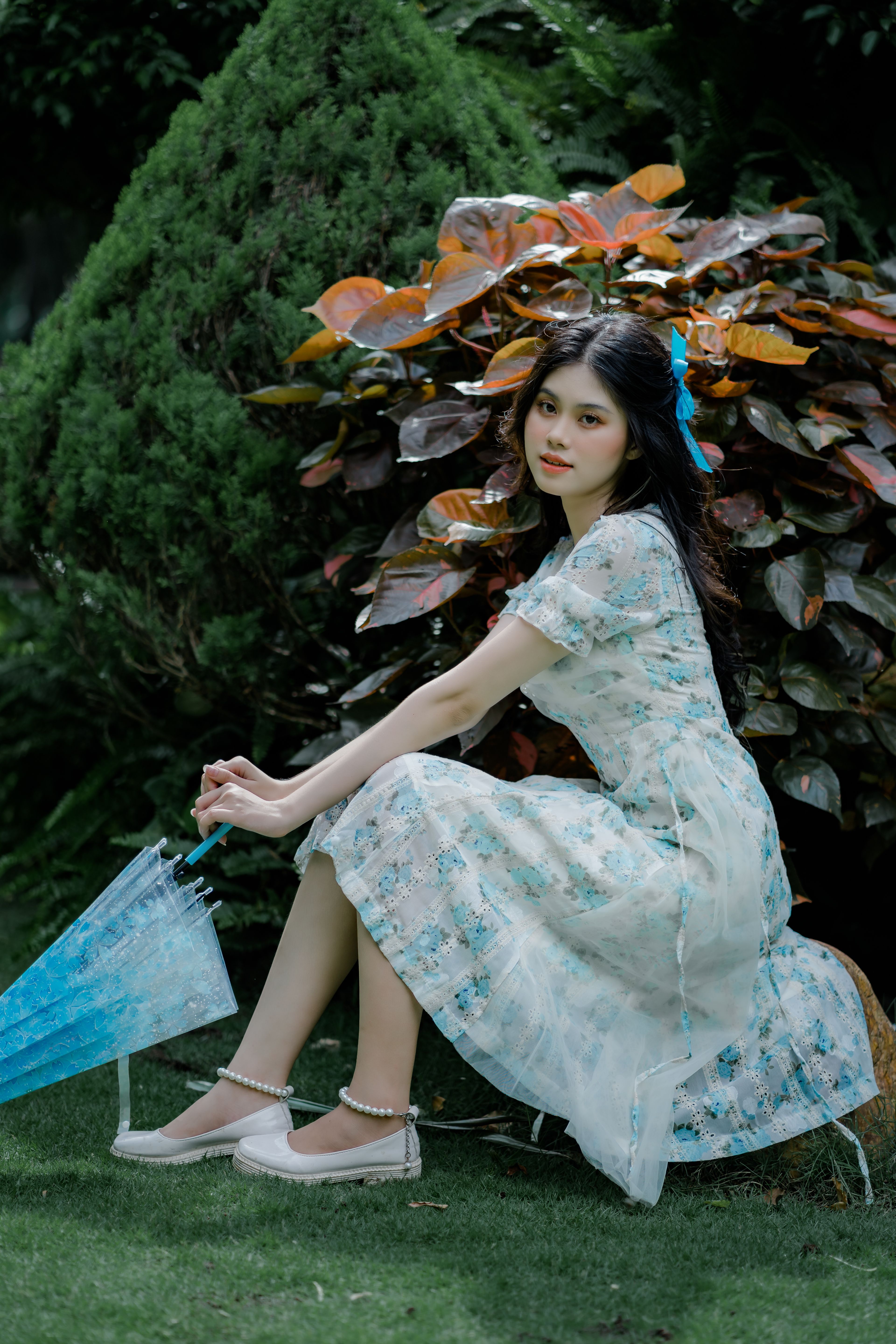 A Woman in White Floral Dress Holding an Umbrella · Free Stock Photo