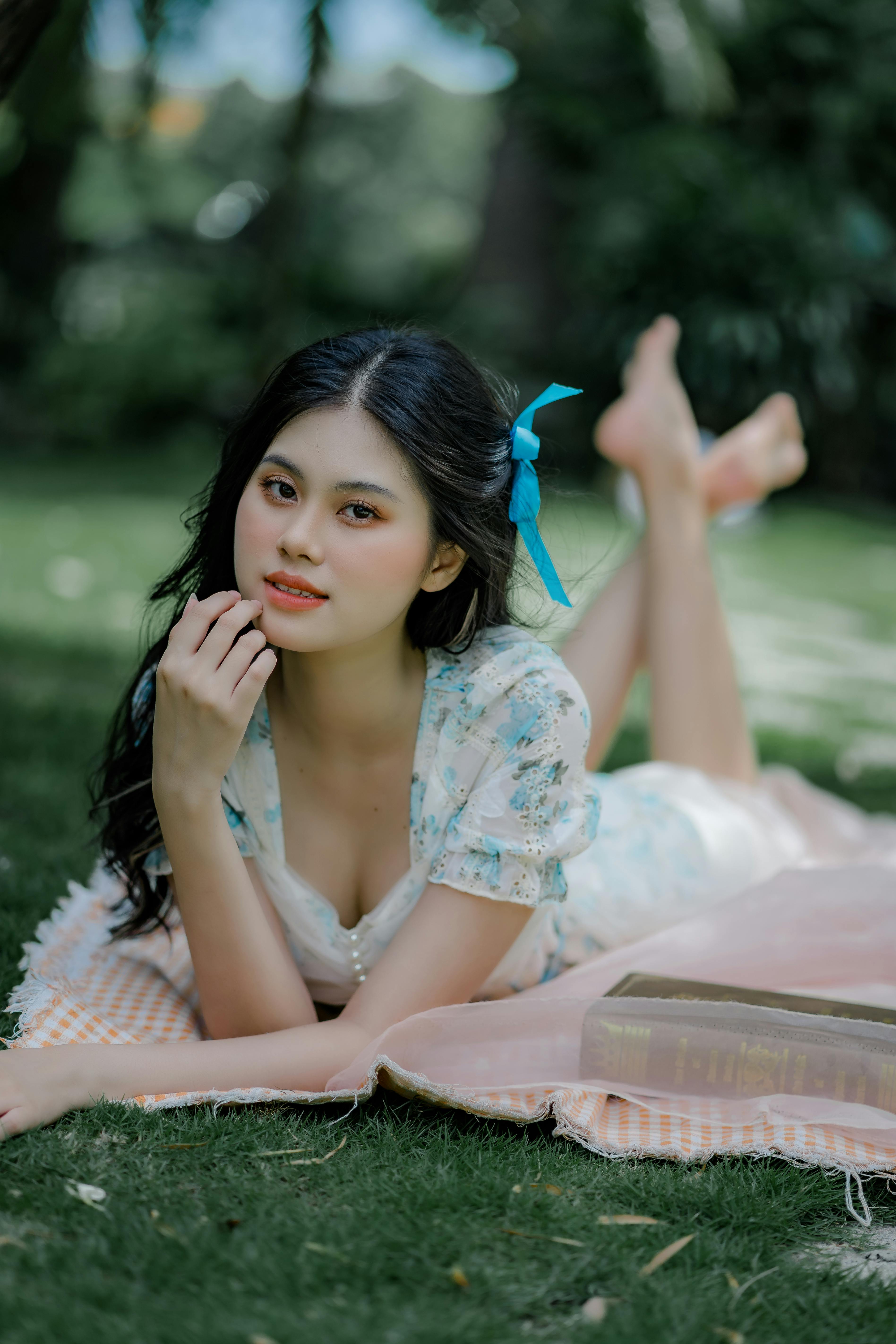 portrait of woman lying on front in a park