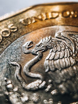 Detailed macro shot of a Mexican coin featuring an eagle and serpent motif.