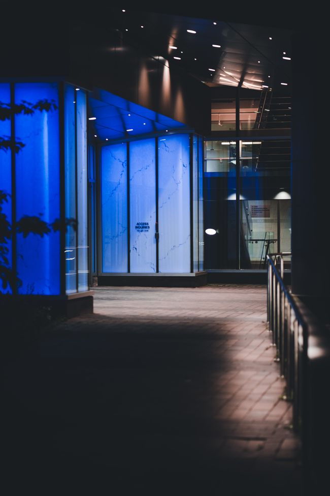 A glass-fronted storefront lit at night. Photo by Erik Mclean on Pexels