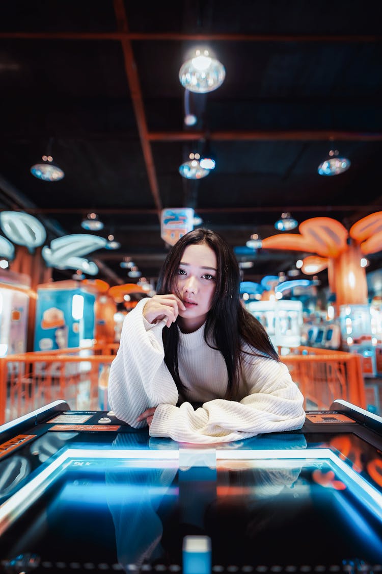 Brunette Woman With Long Hair Sitting At Game Table