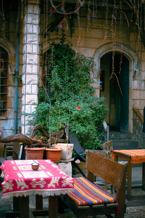 Tables and Chairs in a Patio of an Old Building 