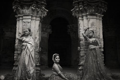 Grayscale Photo of Women in Traditional Indian Clothing