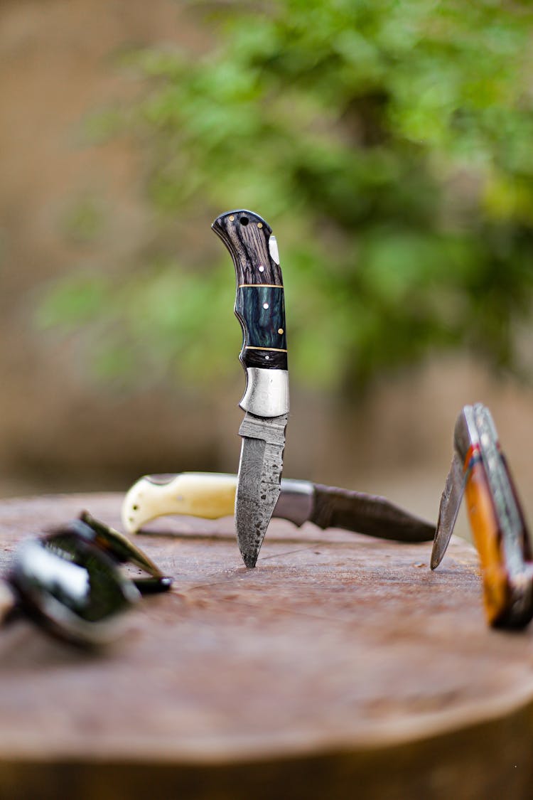 Pocket Knives On Wood