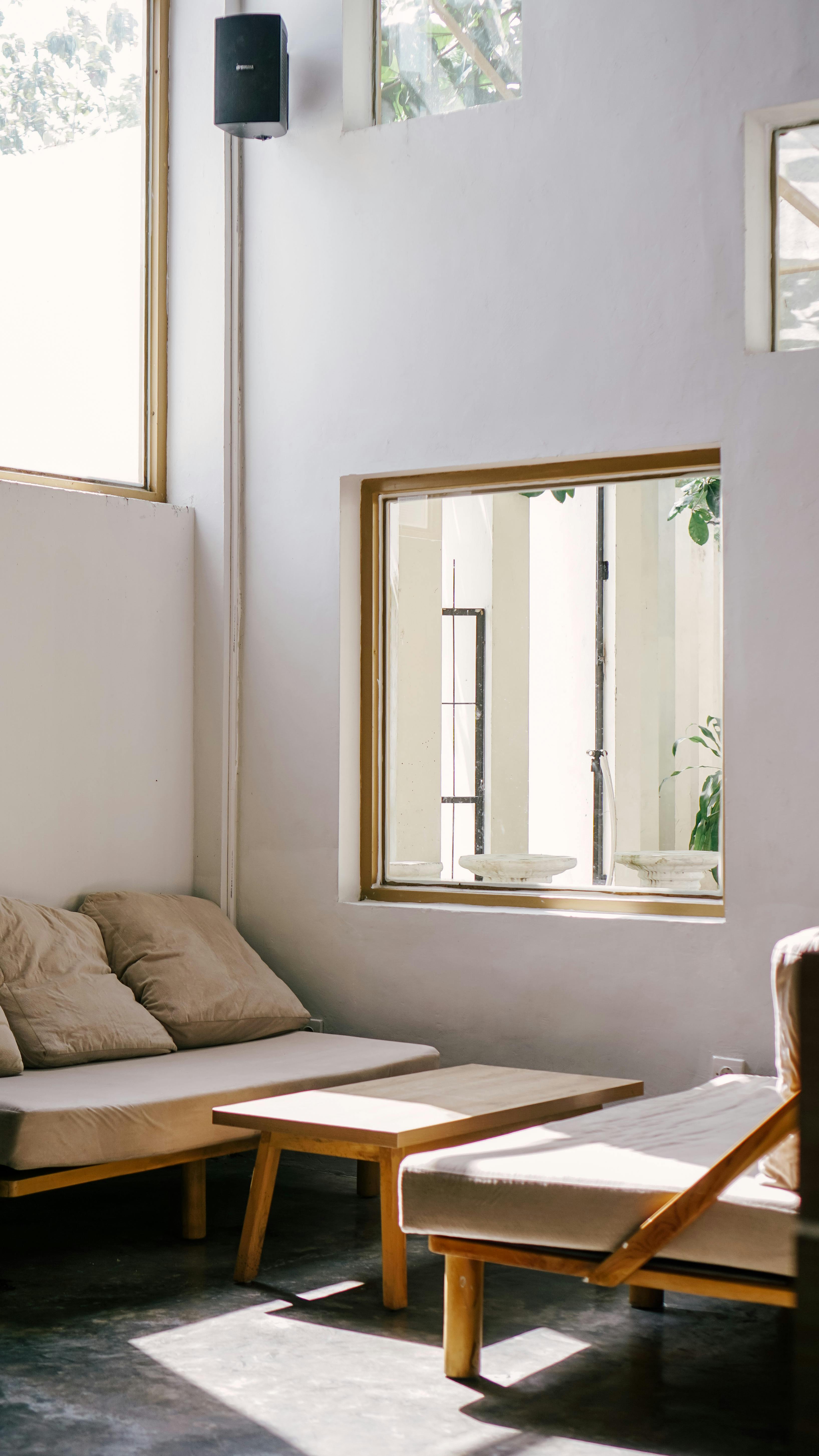 Bright and modern living room featuring minimalist furniture and natural sunlight.