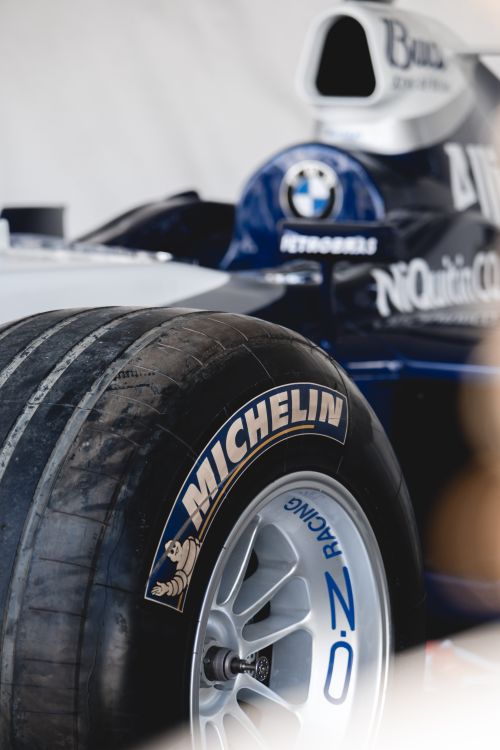 Free Detailed close-up of a Formula 1 car tire highlighting the Michelin branding, showcasing racing precision. Stock Photo