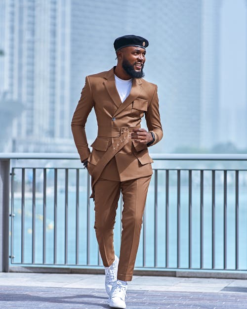 Man Posing in a Beige Suit and Trousers on a City Bridge