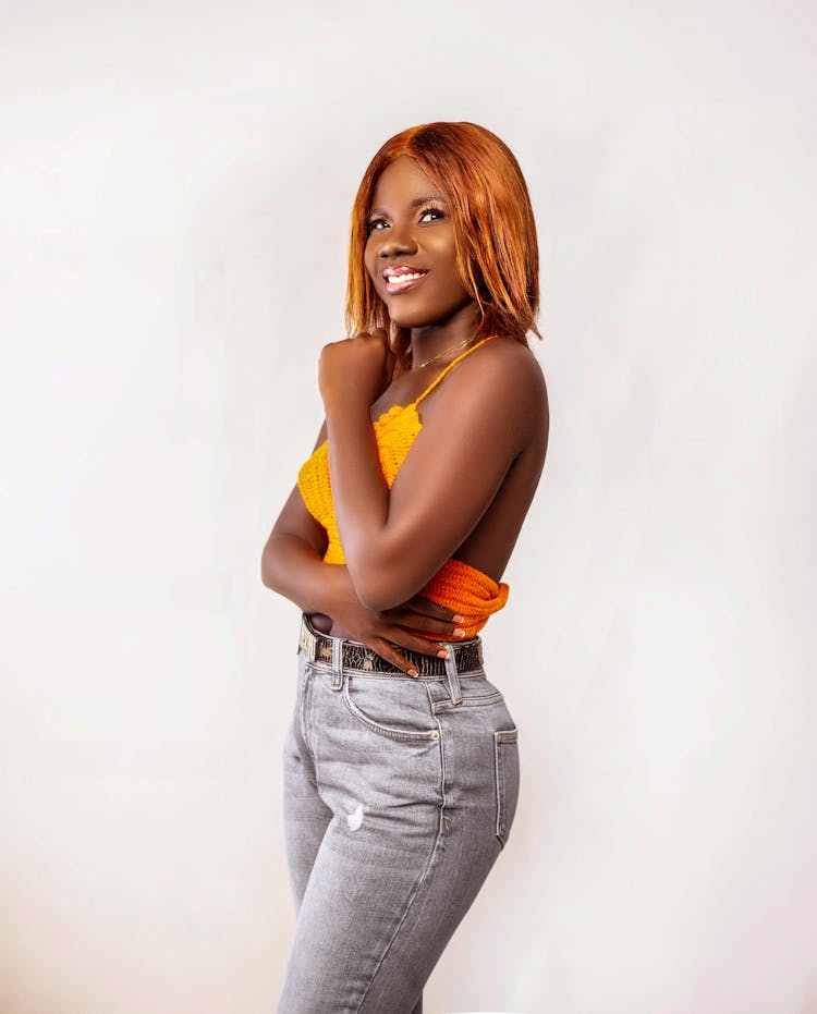 Smiling Woman Wearing An Orange Crochet Top