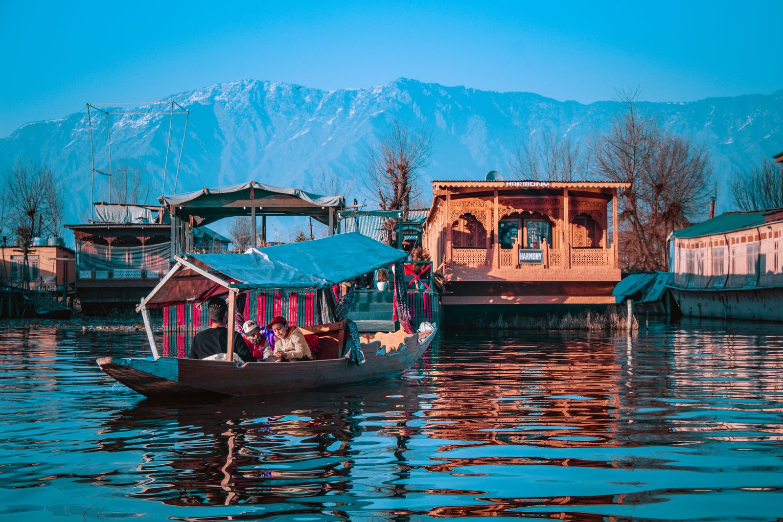 Kashmir Paradise - shikara boats on serene Dal Lake with Himalayan mountains