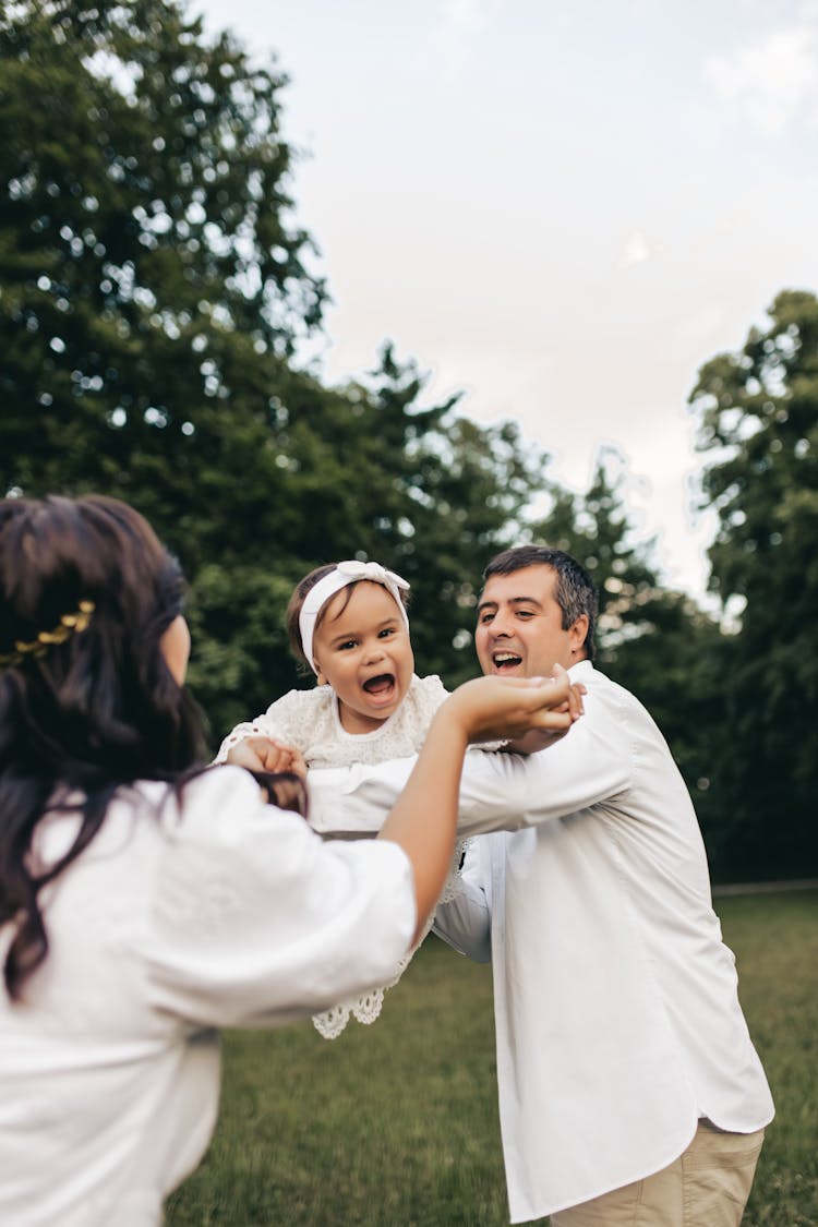 Family Playing In Park