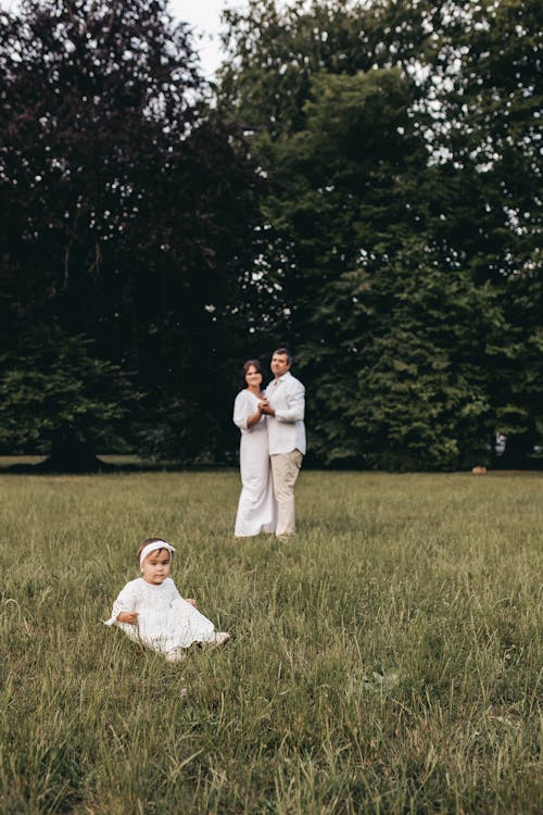 A Girl with her Parents in a Field