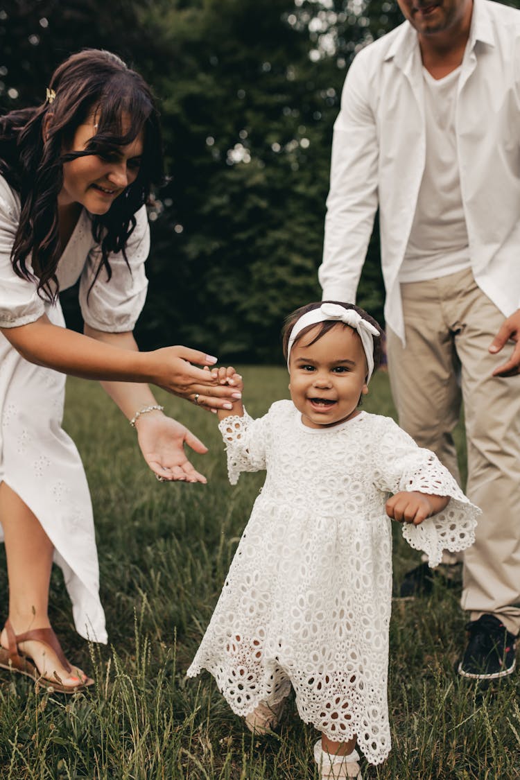 A Mother Teaching Her Daughter To Walk