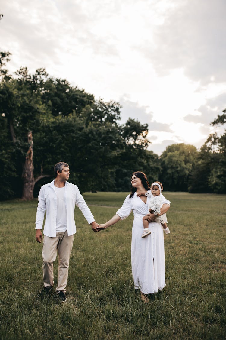 Couple With Baby Holding Hands