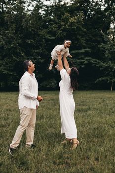 Happy family enjoying time together in a sunny park setting.