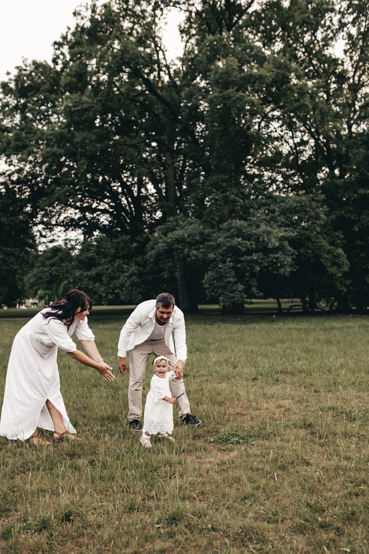 A Family Playing On A Grass Field