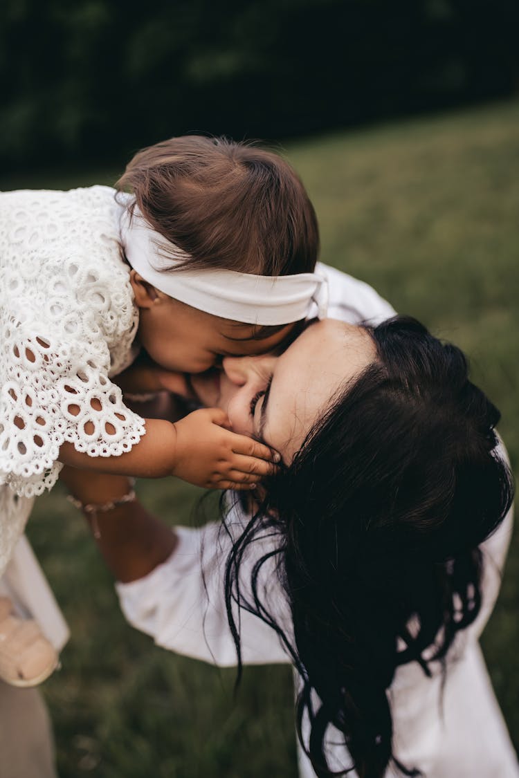 Mother Kissing Daughter