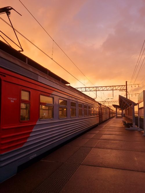Free Passenger train at Saint Petersburg station platform during sunset with dramatic skies. Stock Photo