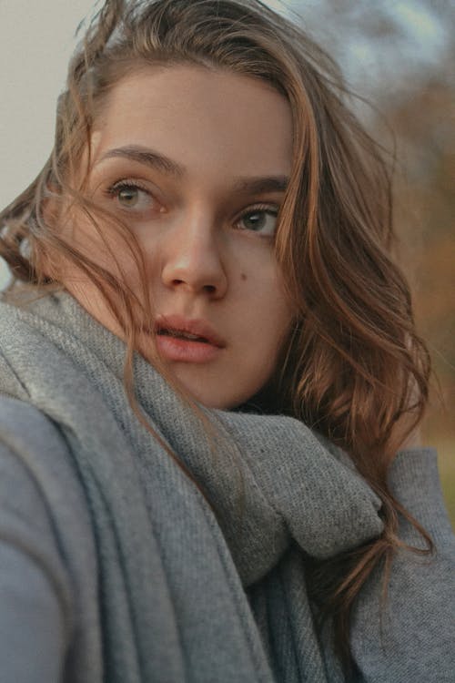 Close-Up Shot of a Woman in Gray Sweater