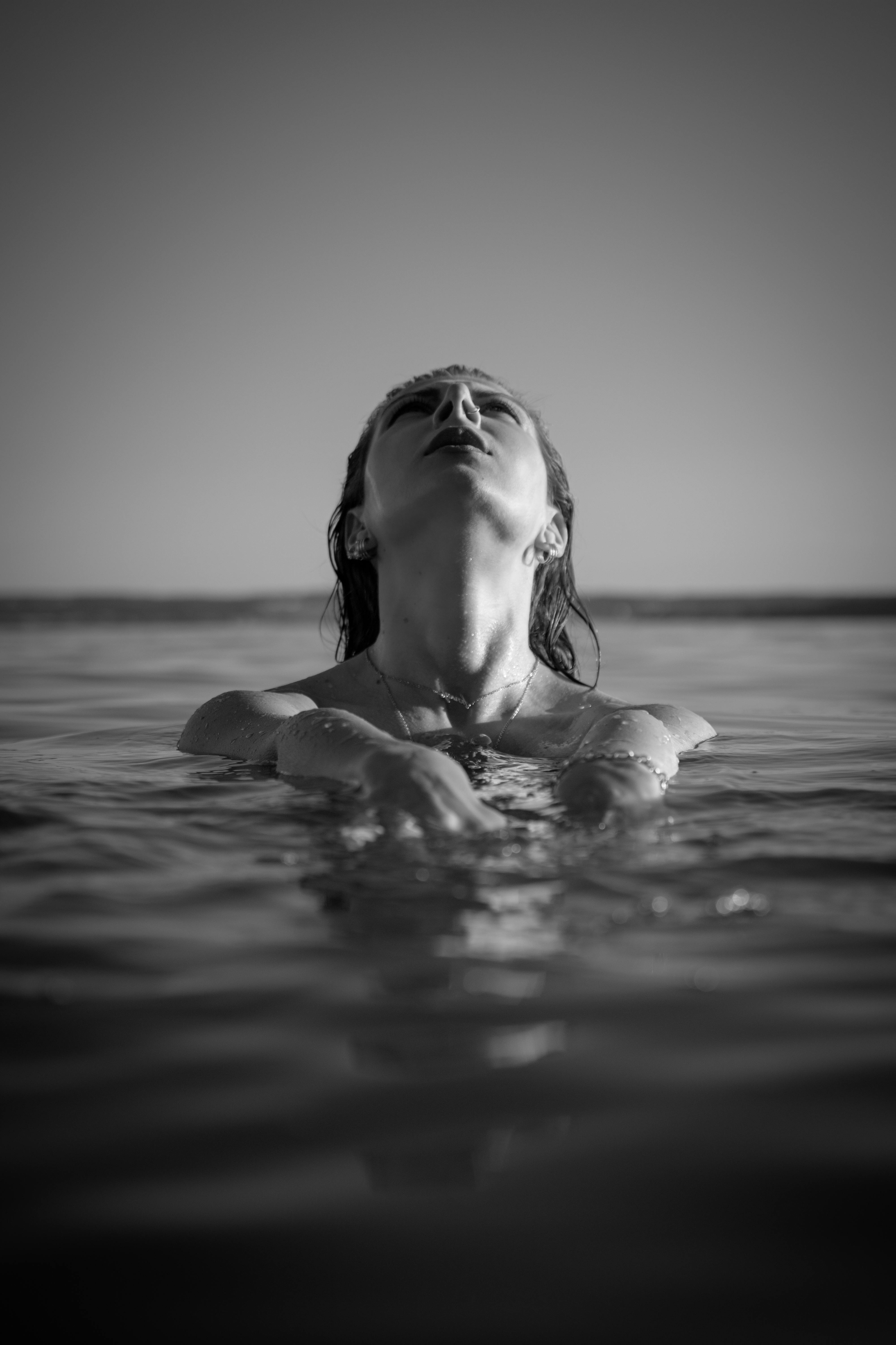 Grayscale Photo of a Woman Swimming · Free Stock Photo