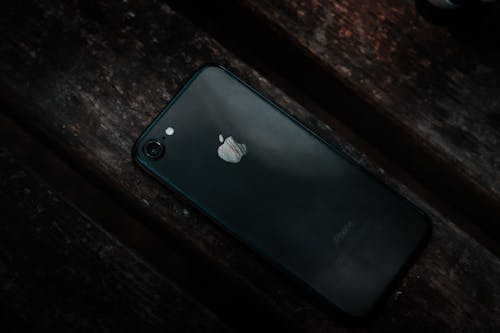Free Photo of iPhone on Brown Surface Stock Photo