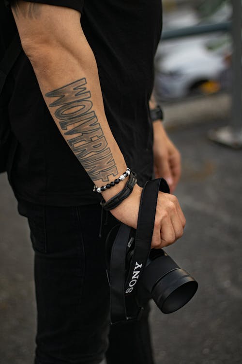 Person in Black Pants Holding a Camera