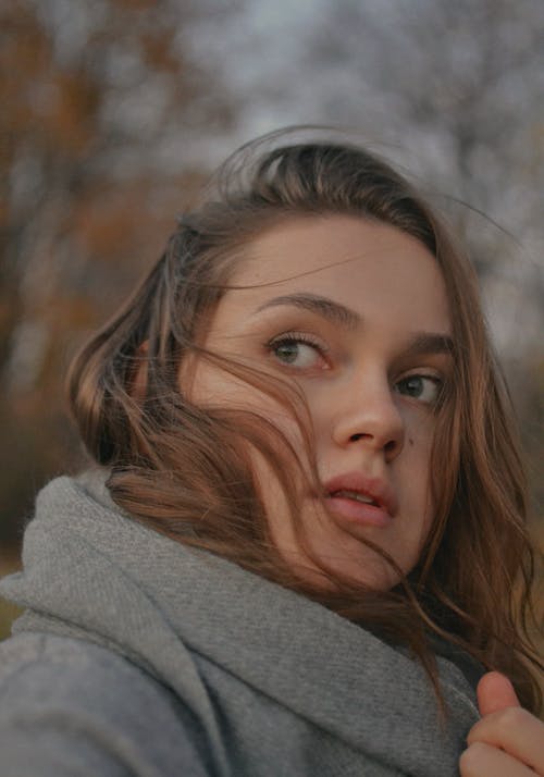 Close-Up Shot of a Woman in Gray Sweater