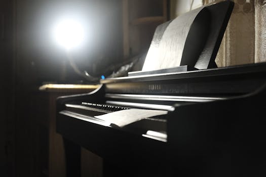 A dimly lit piano with sheet music under a reading light, creating a cozy atmosphere indoors.