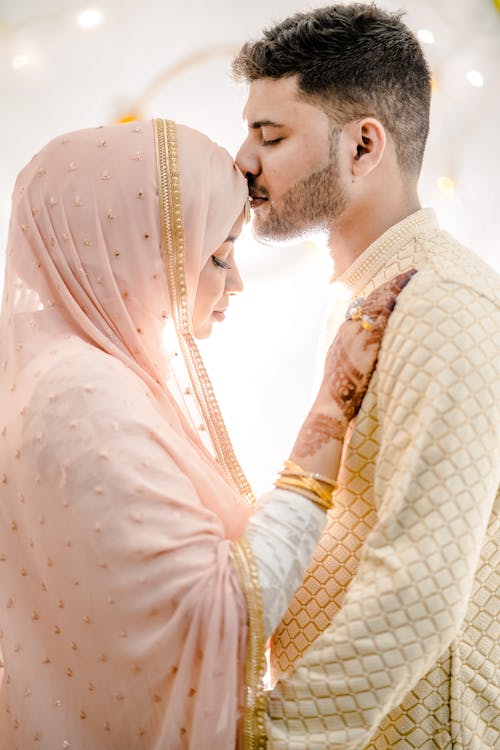 Man Kissing Woman on the Forehead