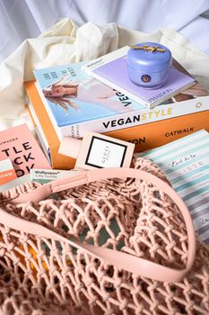Stylish arrangement of accessories, books, and cosmetics in a modern setting.