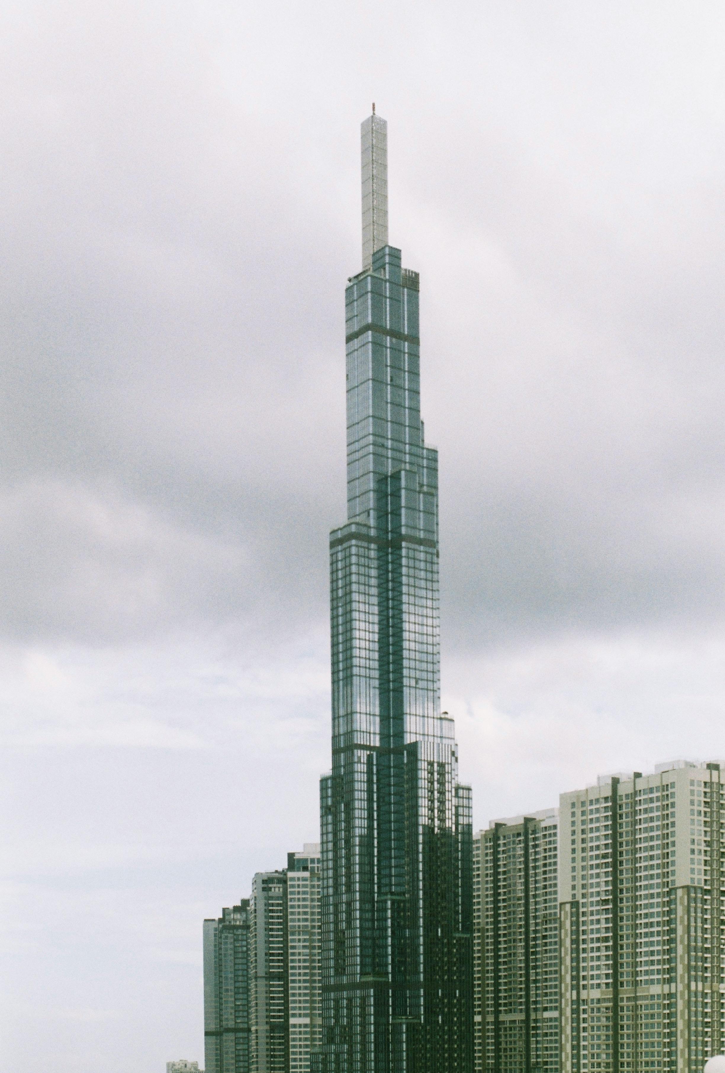 A striking view of Landmark 81 in Ho Chi Minh City, captured against a cloudy sky, highlighting its architectural grandeur.