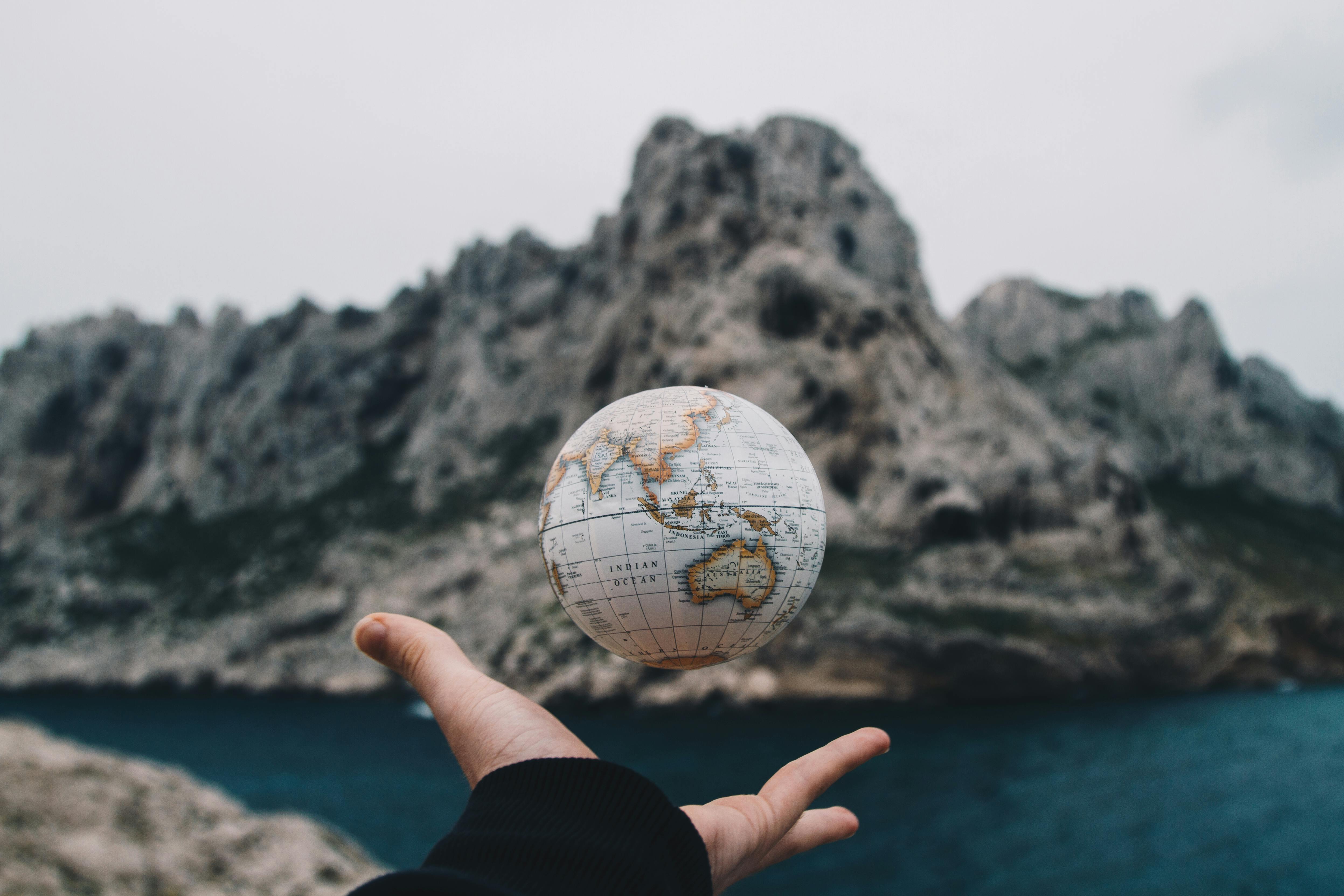 Free Person Tossing Globe Stock Photo