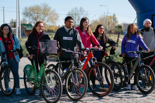 A diverse group of people with bicycles enjoying a sunny day outdoors