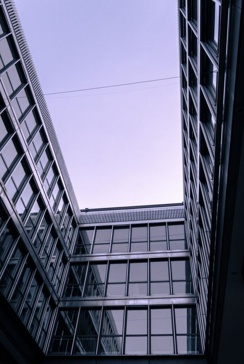 Free Low-angle view of modern glass building in downtown Munich, Germany. Stock Photo