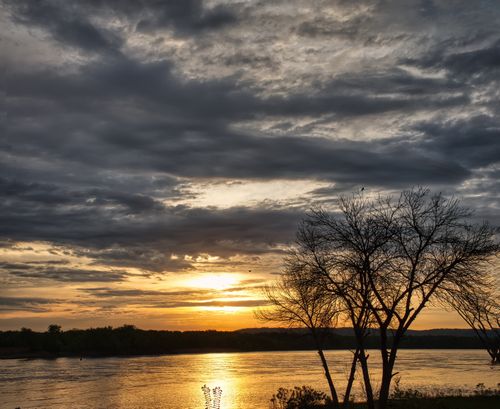 Free Beautiful sunset view over Reads Landing with dramatic clouds and silhouetted trees. Stock Photo