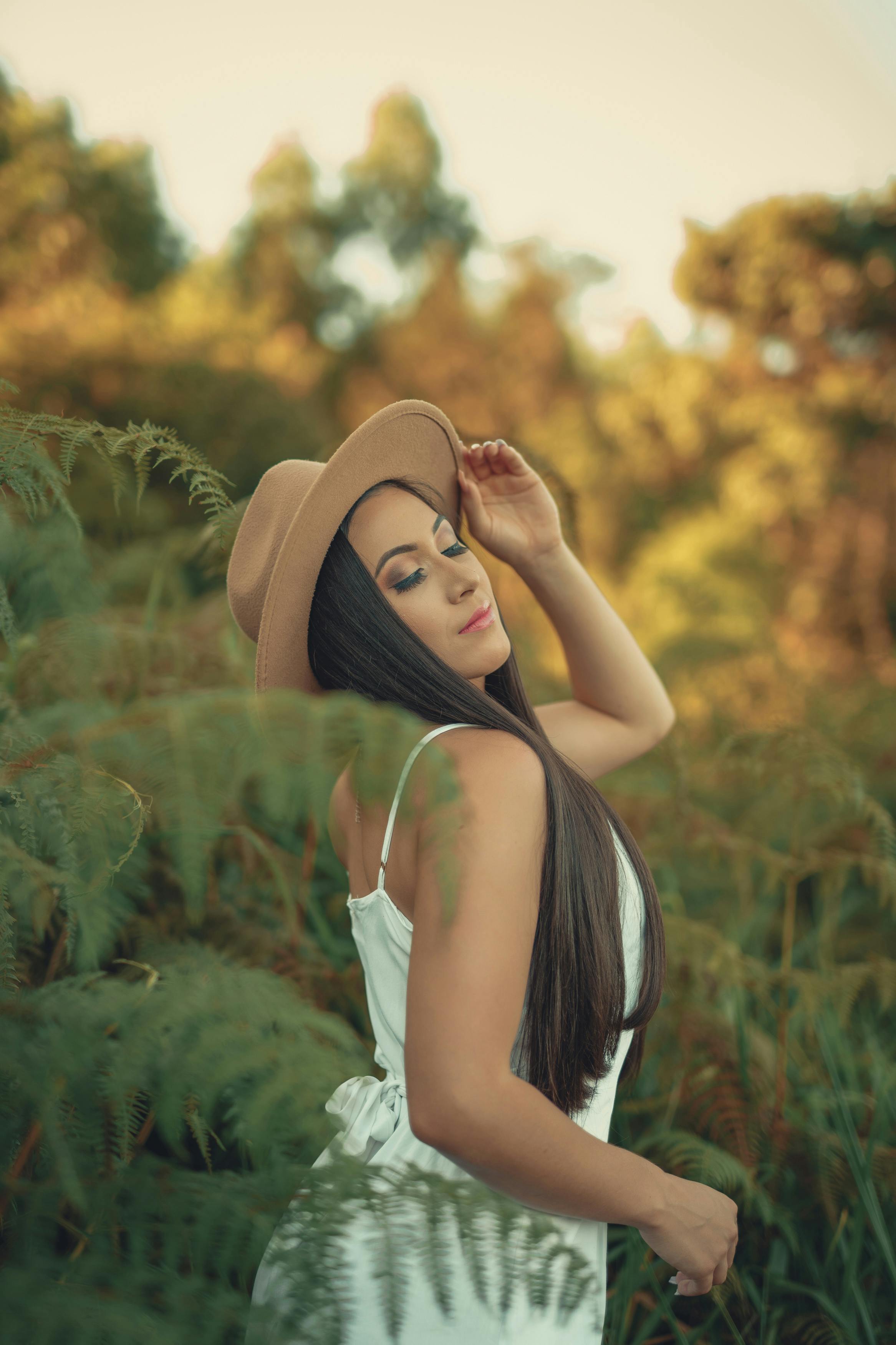 photo of a posing beautiful woman wearing beige hat