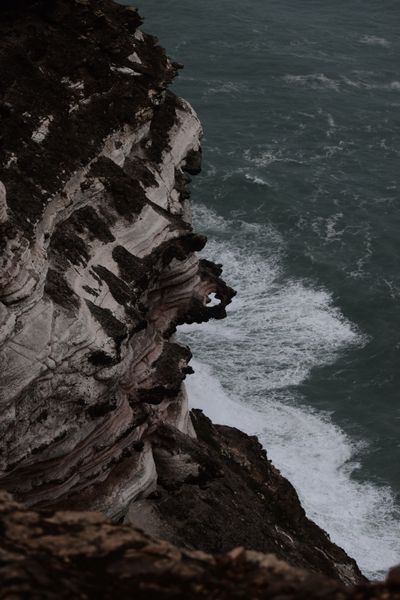 Cliffside surf at dusk, photo by Nandakumar R on Pexels