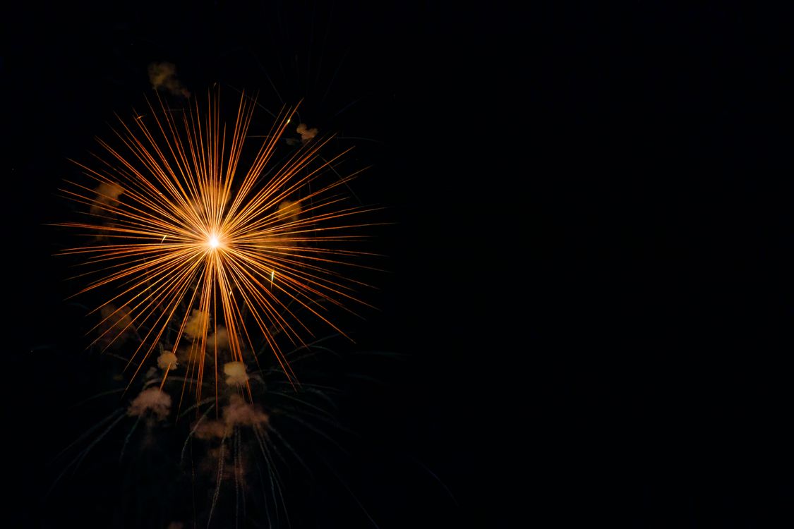 Free A stunning burst of fireworks lighting up a dark night sky, perfect for celebrations. Stock Photo