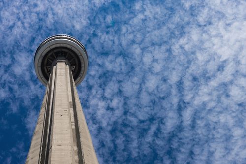 Free Low angle view of the iconic CN Tower with textured clouds in the background. Stock Photo